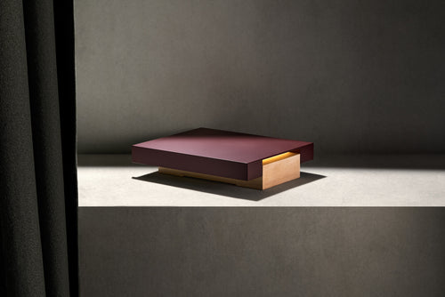 Vora Aegis on a concrete plinth beside a dark curtain, seen from a three-quarter angle